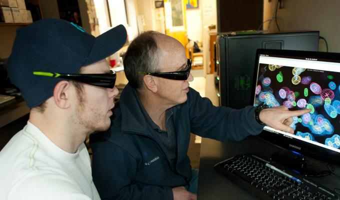 Andy Karplus and student looking over data