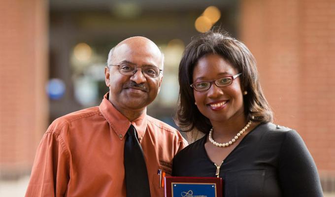 Talithia Williams receiving award from Sastry Pantula