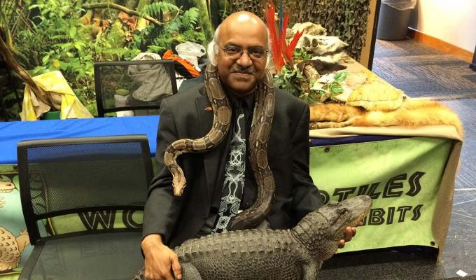 Sastry Pantula sitting with snake and crocodile