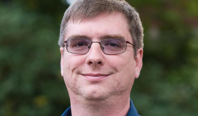 Patrick Reardon standing in front of shrubbery