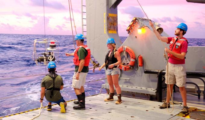 Researchers take a phytoplankton sample on an OSU research vessel.