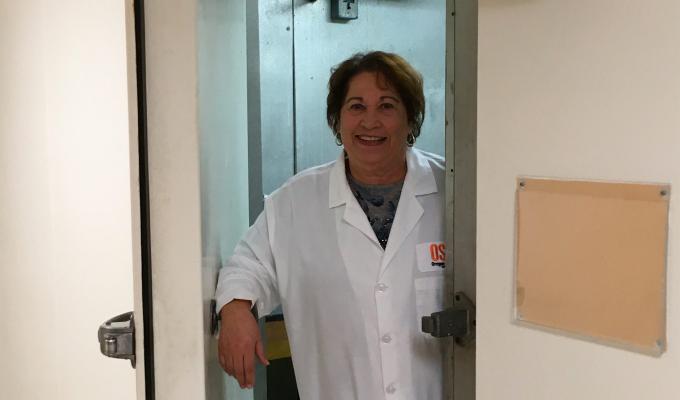 Cindy Fisher standing at a doorway to one of the refrigerator rooms in Nash Hall