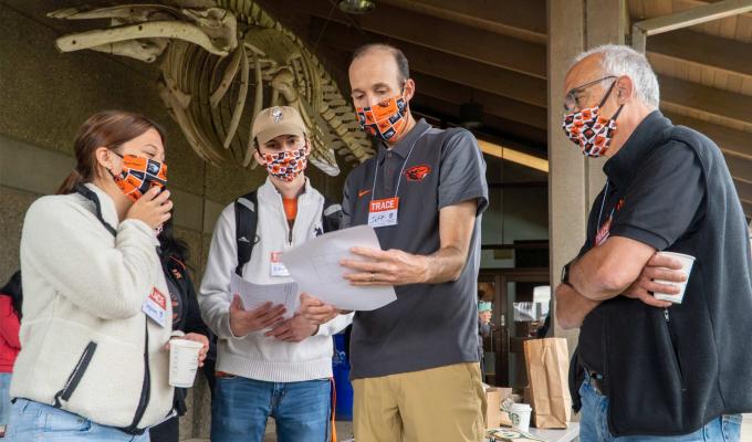 TRACE workers reading paper in group.