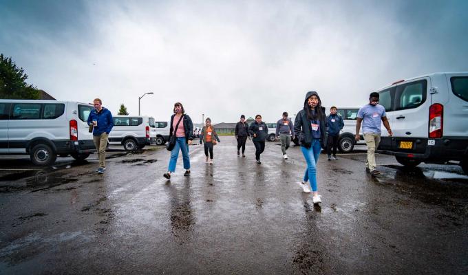 TRACE employees walking in parking lot on a cloudy, wet day in Newport, Oregon