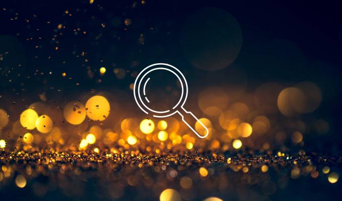 magnifying glass icon above light texture