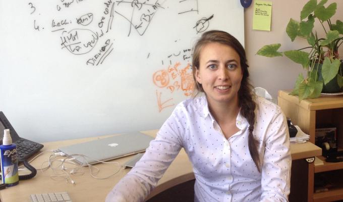 Dr. Maude David sitting at her desk