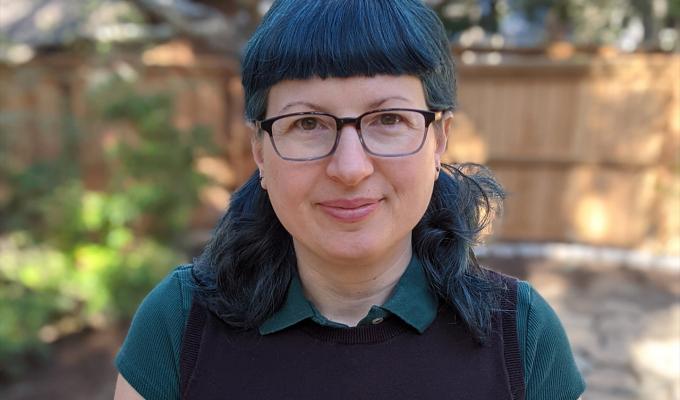 Holly Swisher standing in a backyard.