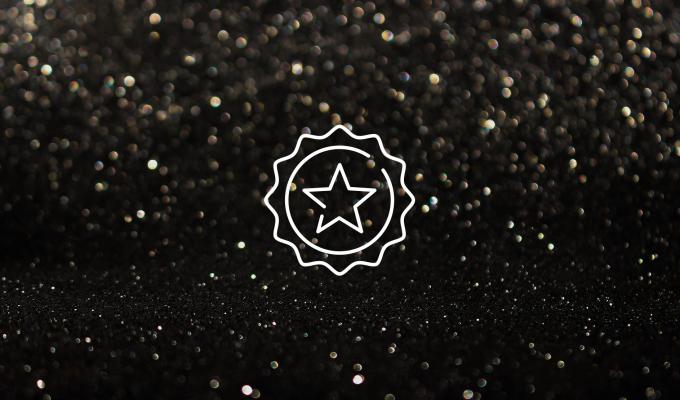 A graphic of a star within a circle, on a background of points of light similar to stars or falling rain. 