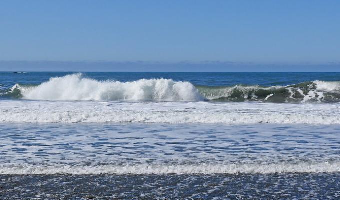 Waves crashing against the sand