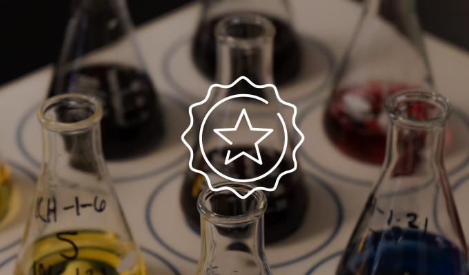 Graduated beakers with colorful liquid in them 