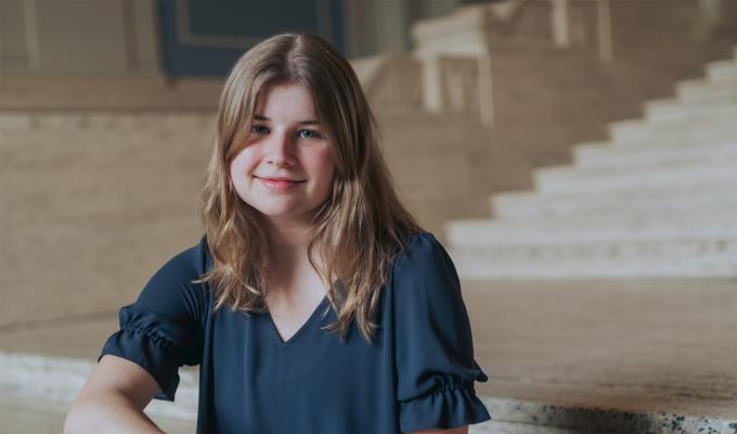 Grace Petrina, a woman with long blonde hair, in a dark blue shirt.