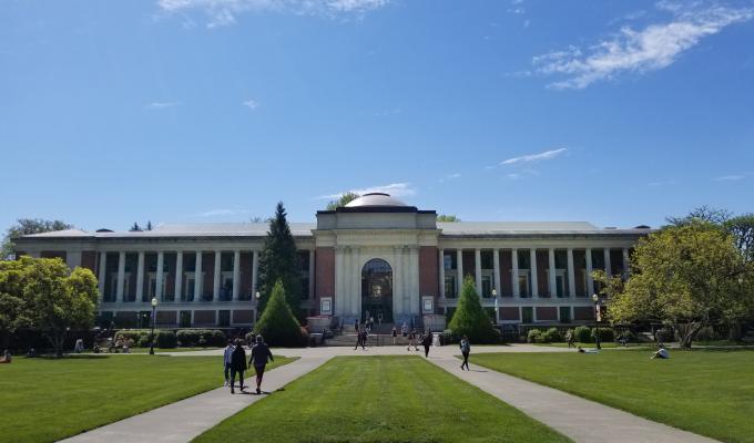 Memorial union in the background with sunshine and people walking.