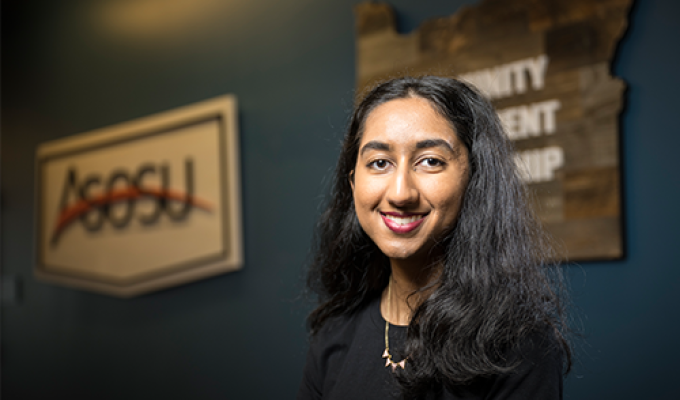 Sahana Shah smiles for the camera in a black shirt.