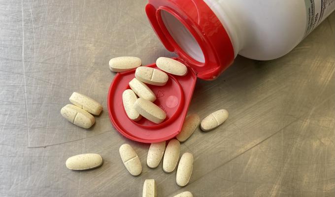 A spilled bottle of white pills.