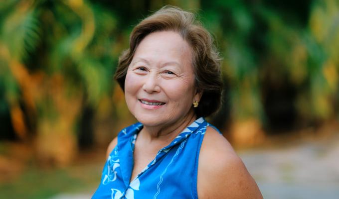 Jo-Ann Leong smiling on a beach in Hawaii