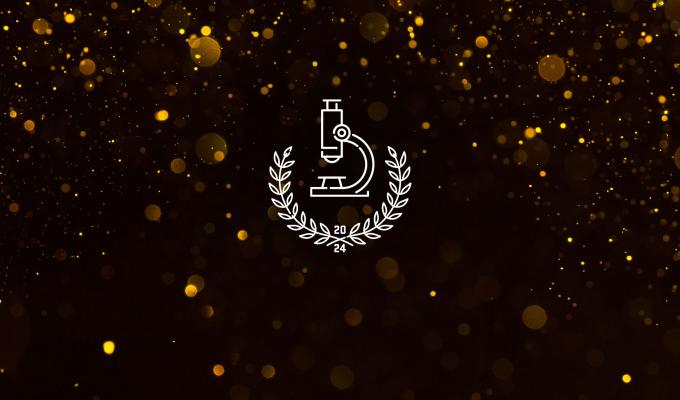 A microscope illustration with golden confetti in the background.