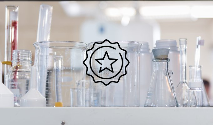 A graphic of a star is in front of lab test tubes.