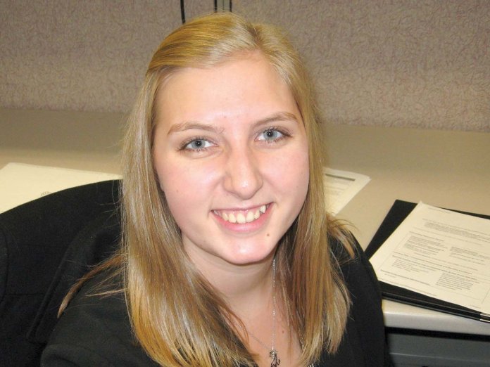 Susan Dunham sitting in cubicle