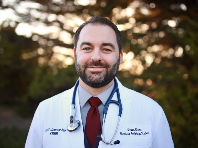 Steven Kurtz in a doctor coat and stethoscope