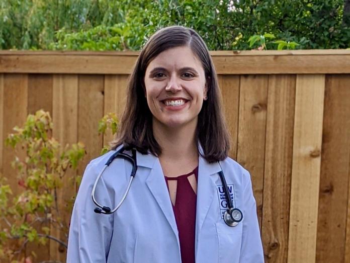 Joely Hannah, outside in a white lab coat