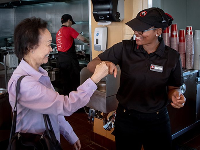 Peggy Cherng with a Panda Express employee.