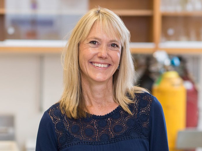 Smiling headshot of Kim Halsey in her lab