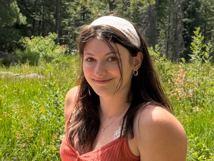 Smiling woman sitting in a field