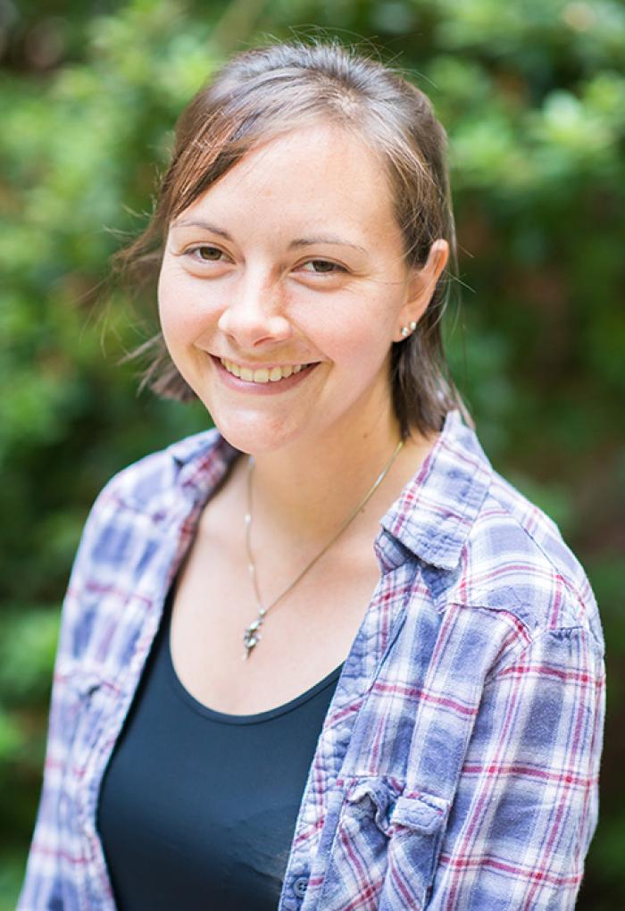 Andrea Burton in front of shrubbery