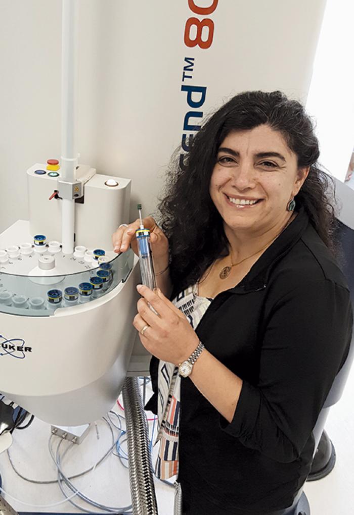 Elisar Barbar working with lab equipment