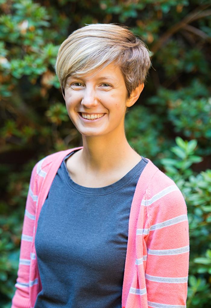 Claire Couch standing in front of shrubbery
