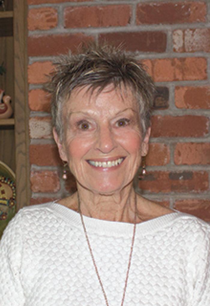 Kay Merrill in front of brick wall