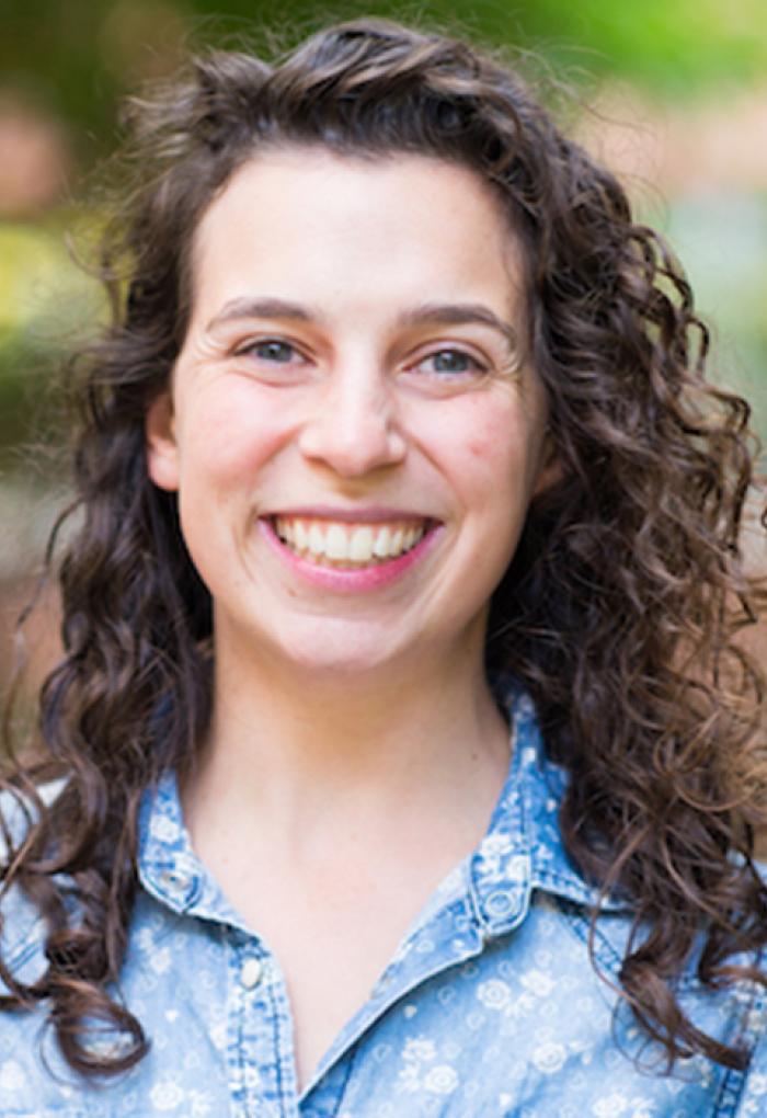 Rebecca Mostow in front of shrubbery