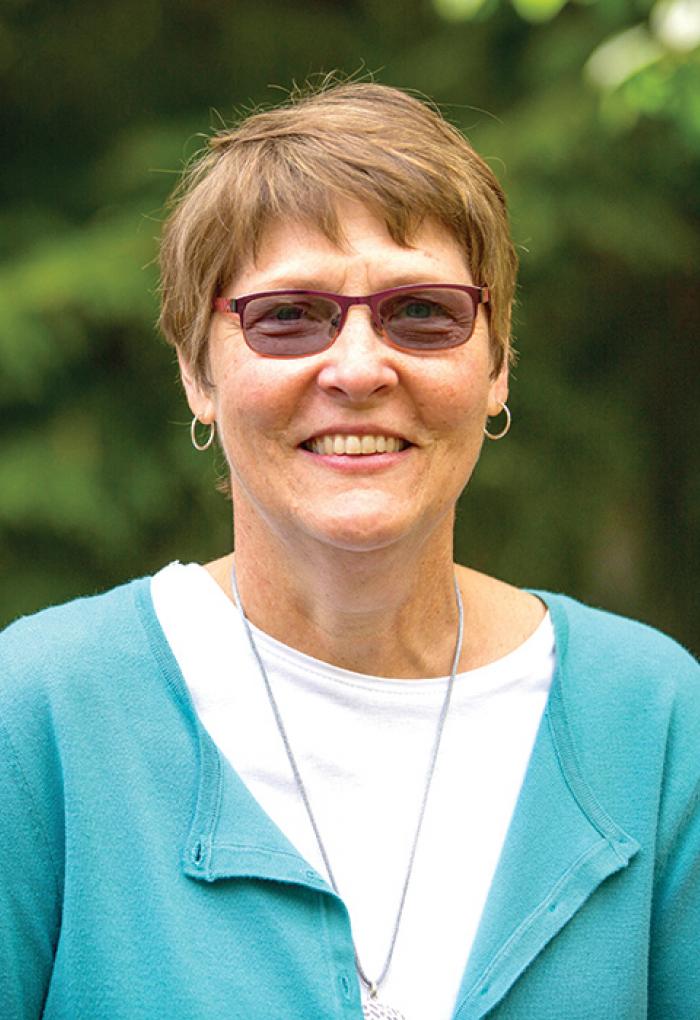 Virginia Lesser in front of shrubbery