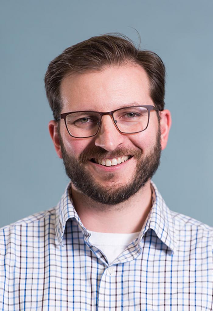 Thomas Sharpton in front of grey backdrop