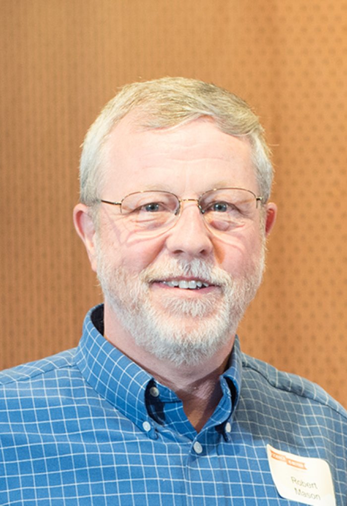 Robert Mason in front of wood backdrop