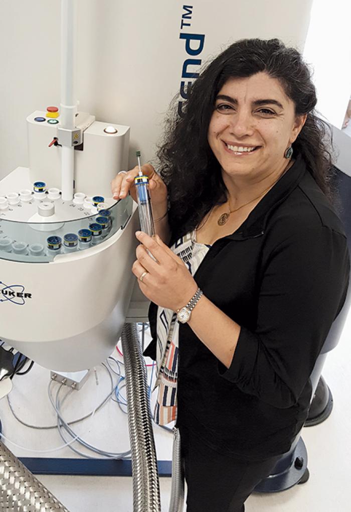 Elisar Barbar working with lab equipment