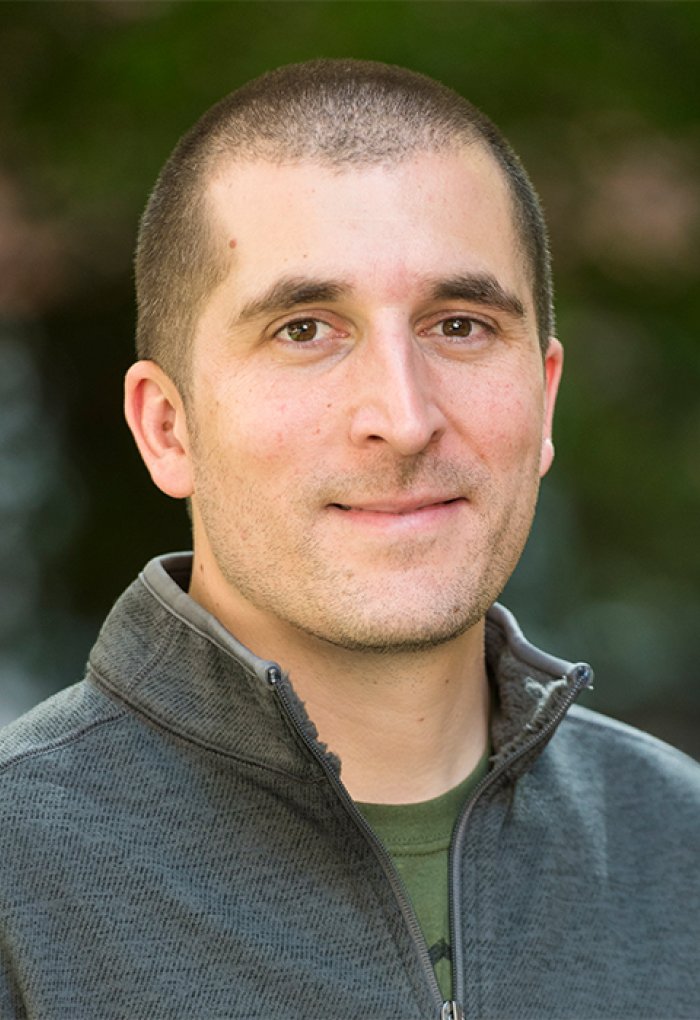 Adam Chouinard in front of shrubbery