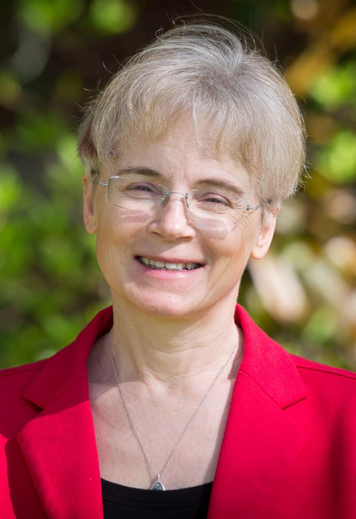 woman in red jacket standing outside