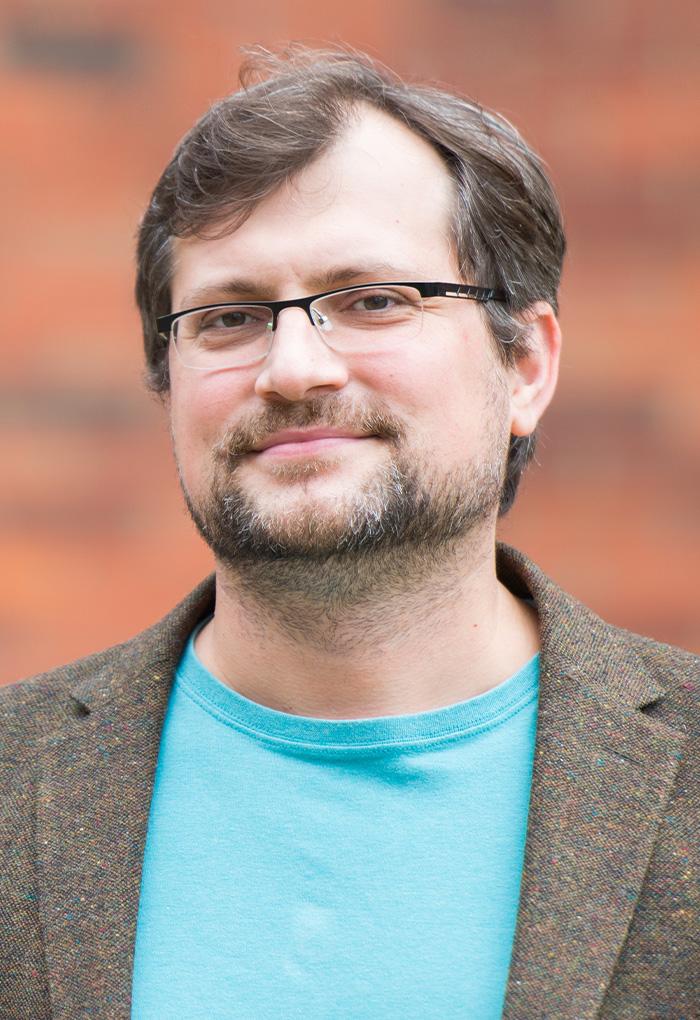 Radu Dascaliuc, a man with glasses and a beard.