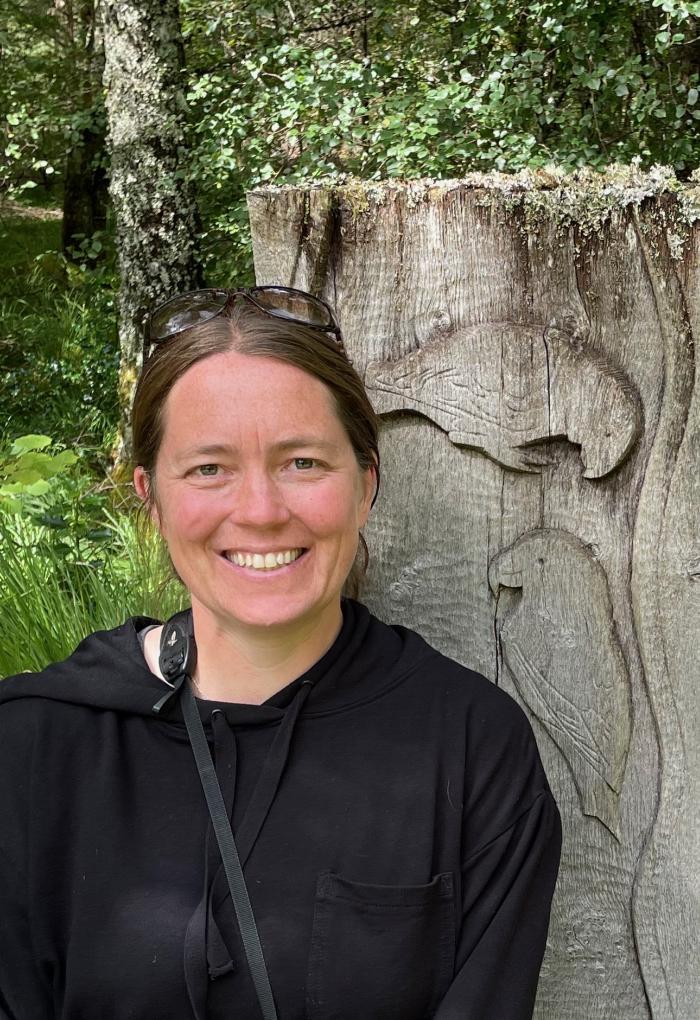 Jamie Cornelius in front of a crossbill bench in Scotland.