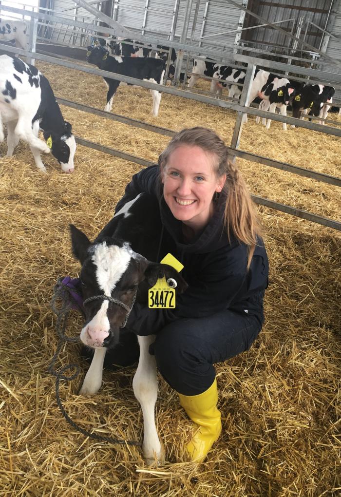Karianna Crowder hugging a cow and smiling for a photo.