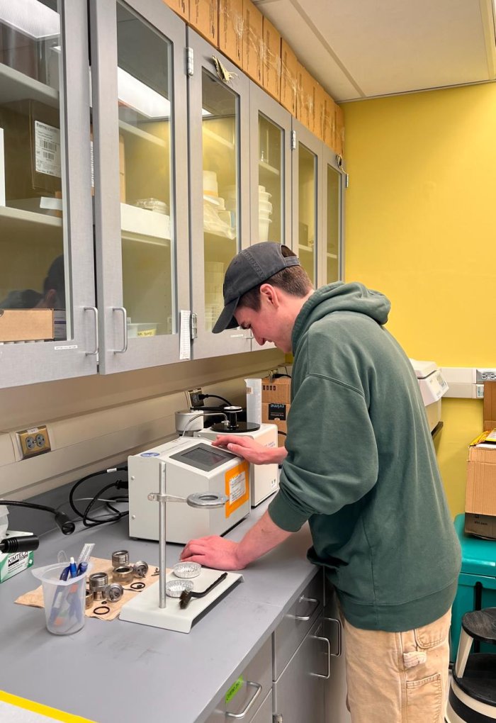 A man in a sweatshirt in a laboratory.