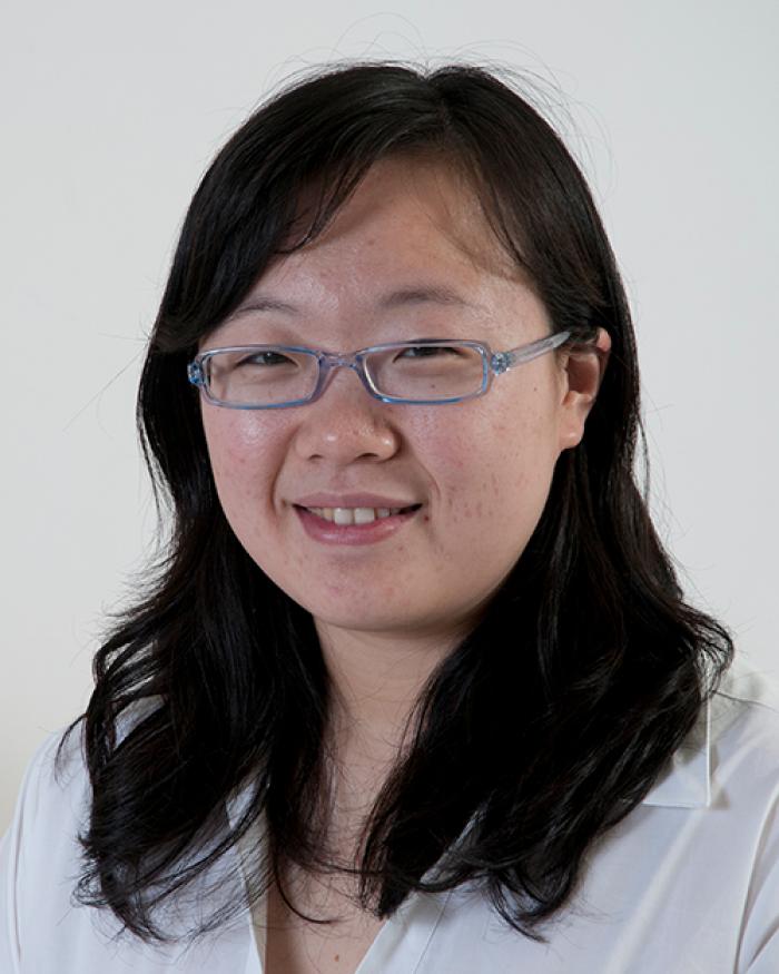 Jie Zhang in front of white backdrop