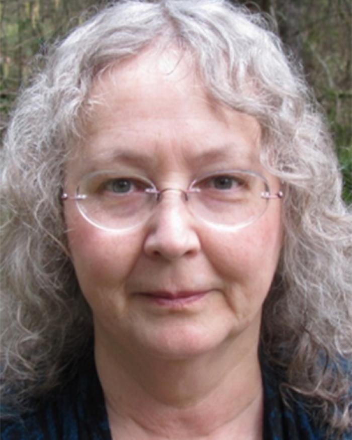 Kathryn Hadley in front of shrubbery