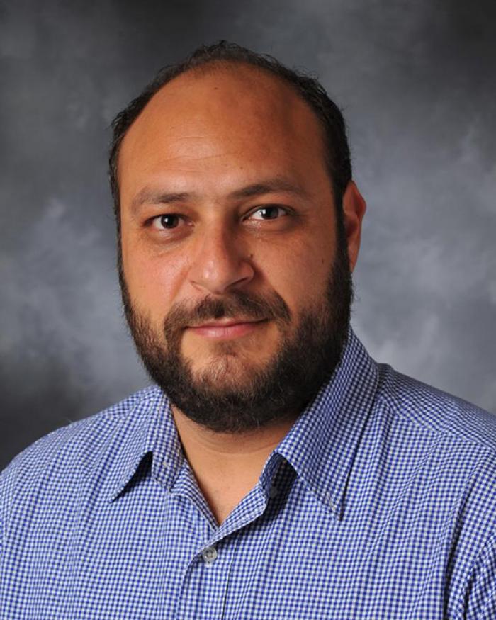 Kyriakos Stylianou in front of grey backdrop