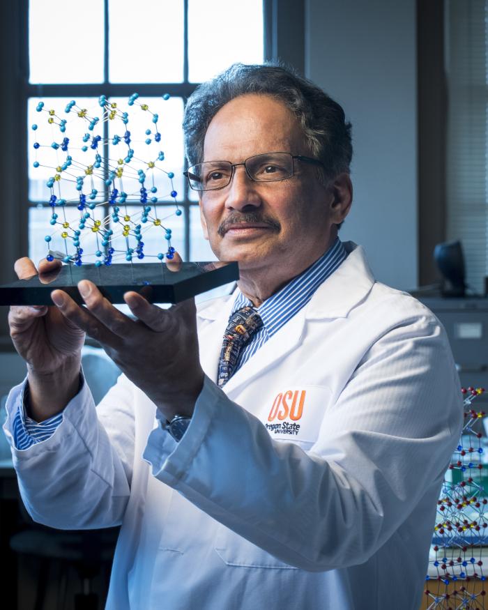 Picture of Professor Mas Subramanian with a Molecular Model of YInMn Blue