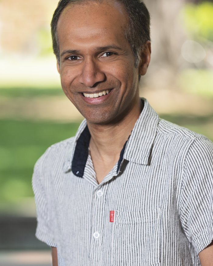 Instructor Amila Liyanage smiling on campus
