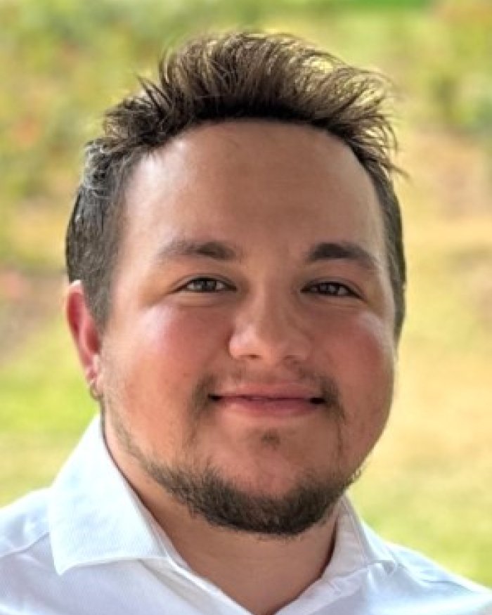 Hayden Campos standing outside smiling.