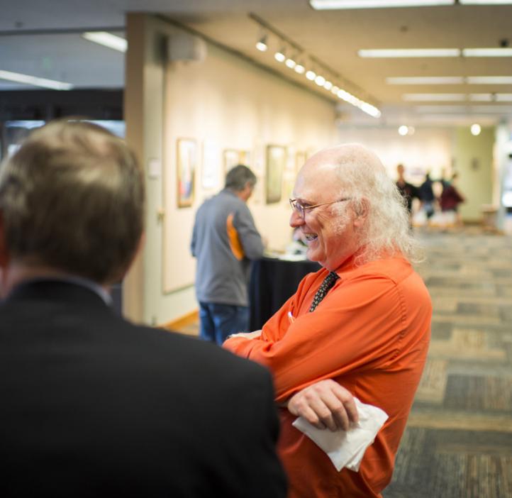 Kevin Ahern chatting with colleague in lobby