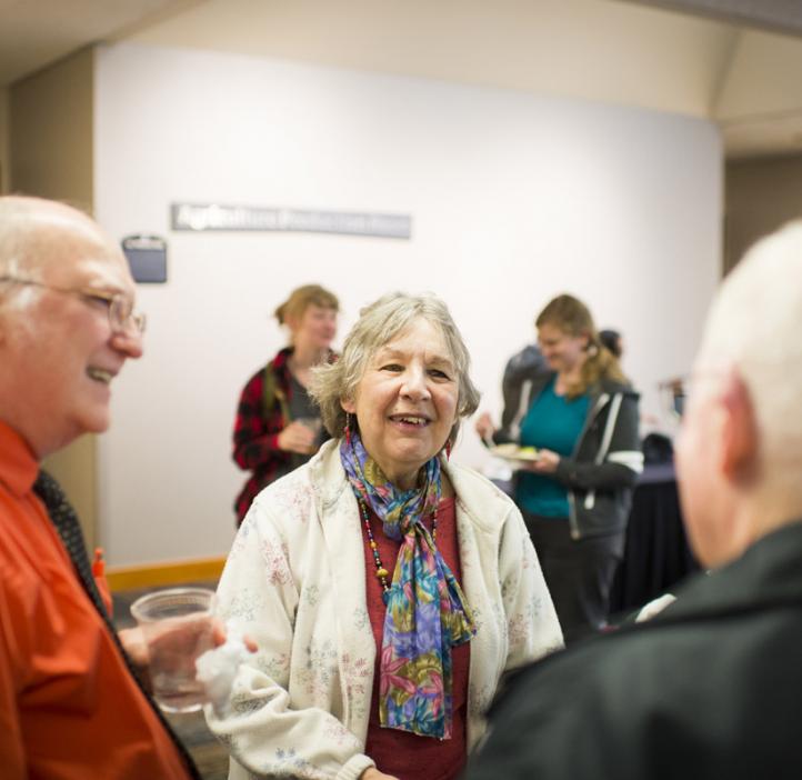 Kevin Ahern chatting with colleagues in lobby